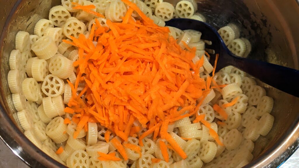 Adding Shredded Carrot to Vinegared Pasta