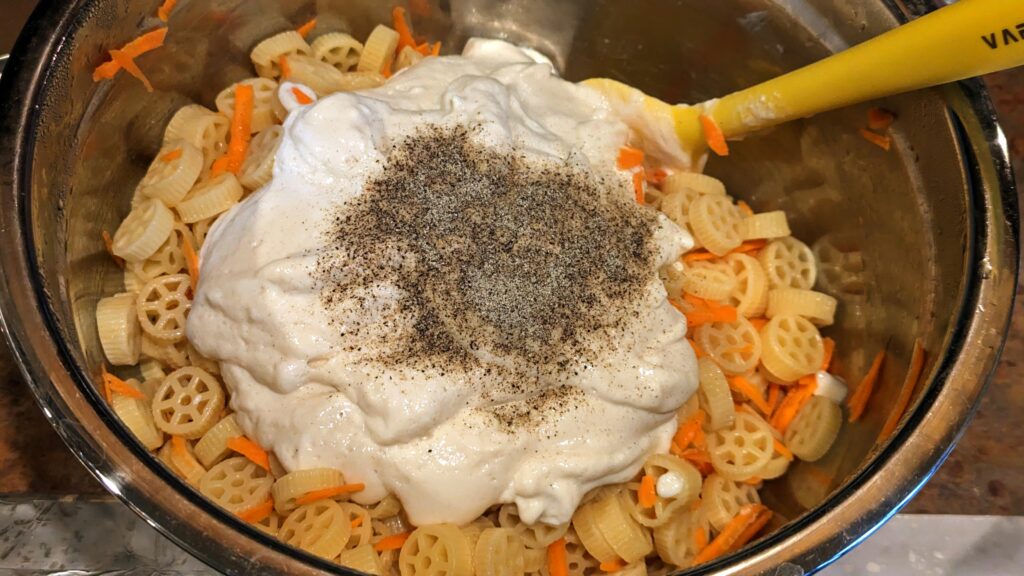 Adding Sauce and Pepper to Seasoned Pasta